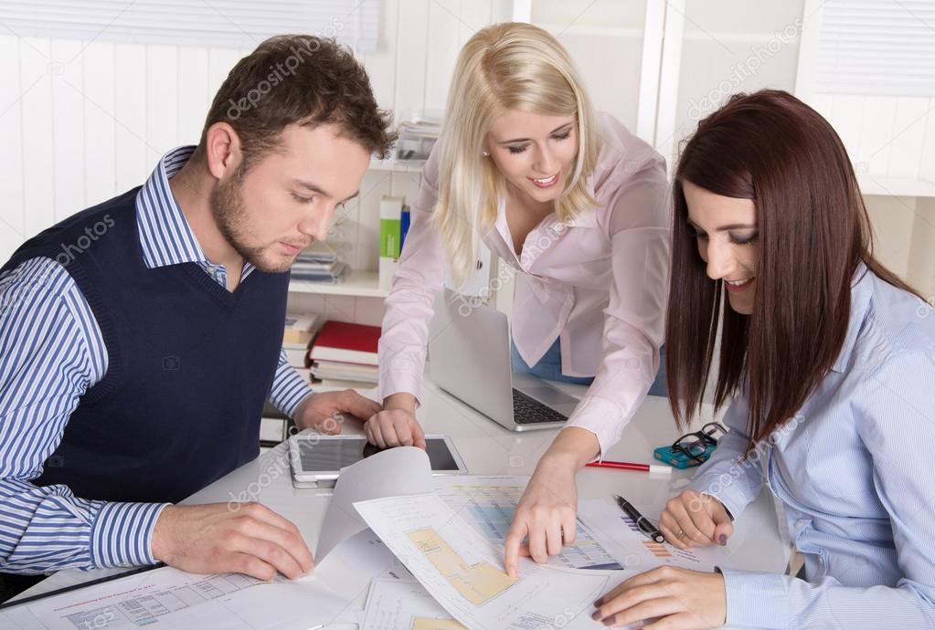 Business team sitting around a table in a meeting.