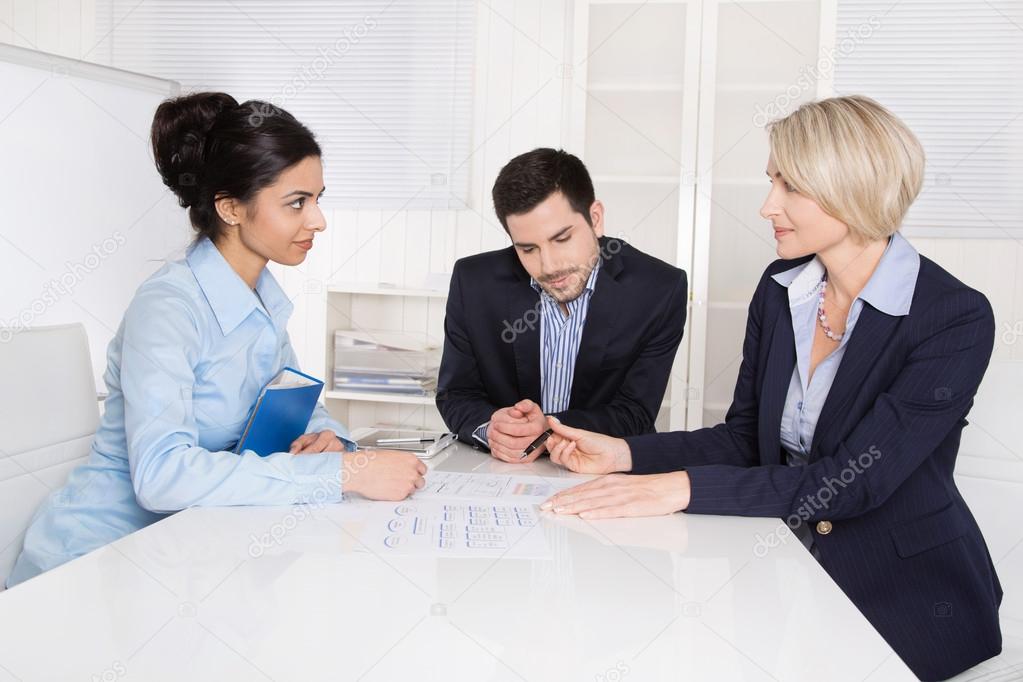 Job interview: group of businesspeople sitting around a table.