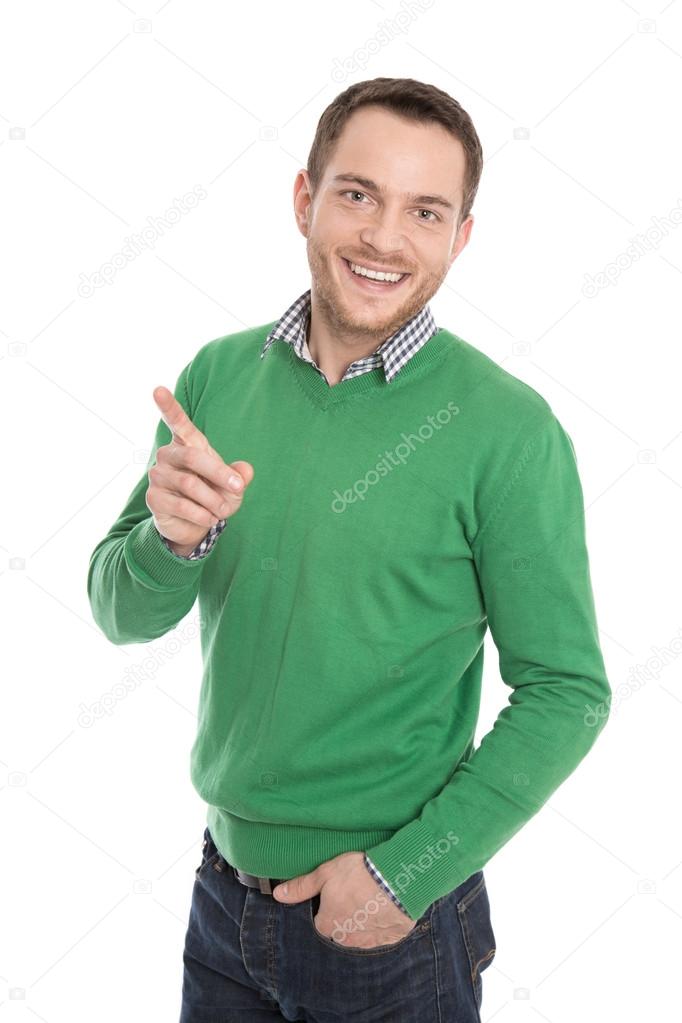 Isolated happy man in green presenting with forefinger.