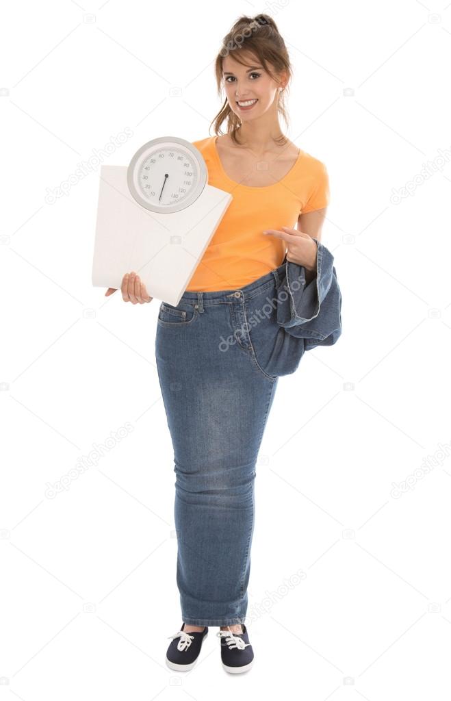Beautiful young woman holding balance scales in her hands.