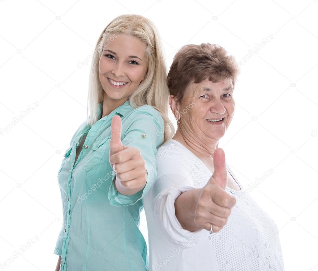 Isolated happy grandmother and granddaughter with thumbs up.