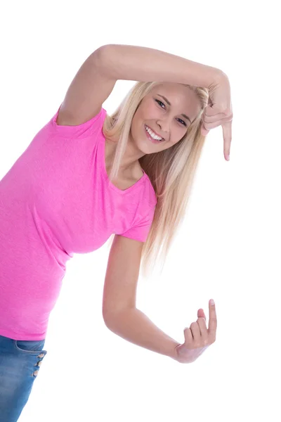 Usměvavá mladá dívka izolován v růžové tričko prezentace s prstem — Stock fotografie