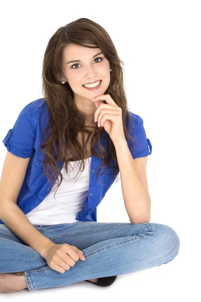 Isolated young pretty smiling teenager sitting with crossed legs. — Stock Photo, Image