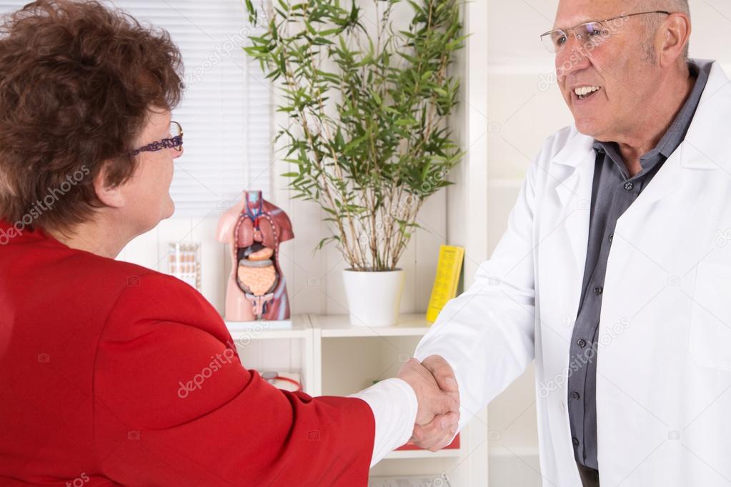 Smiling doctors says hello to his female patient.