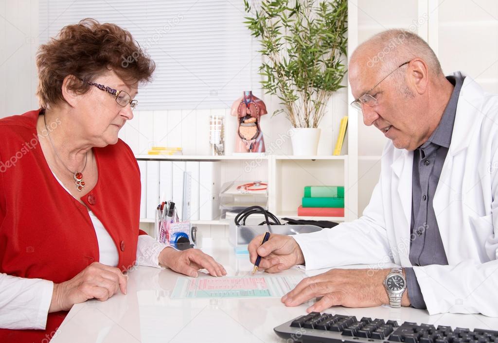 Portrait: older doctor with experience talking with senior woman