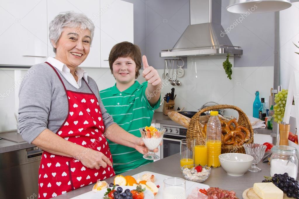 Happy family: Grandmother and grandson cooking together.