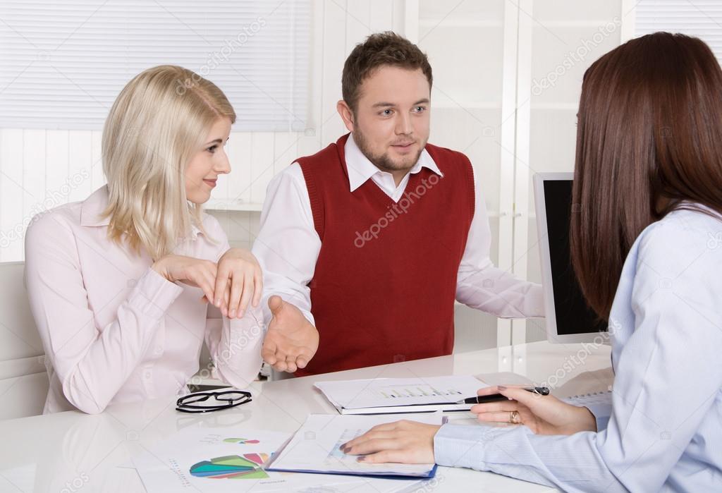 Financial business meeting: young married couple - adviser and c
