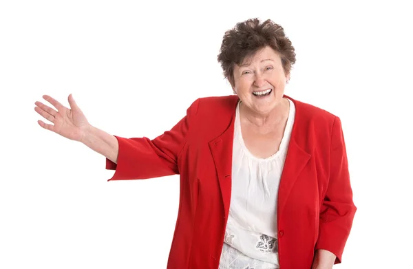 Šťastný izolované starší žena v červené prezentace s rukou. — Stock fotografie