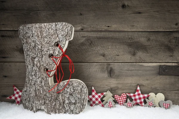 Trä jul bakgrund i röd och grå med santa boot. Stockbild