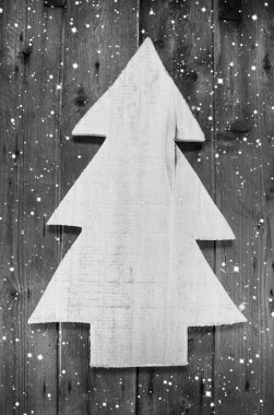 Wooden handmade christmas tree in shabby style on a wood snowy b clipart