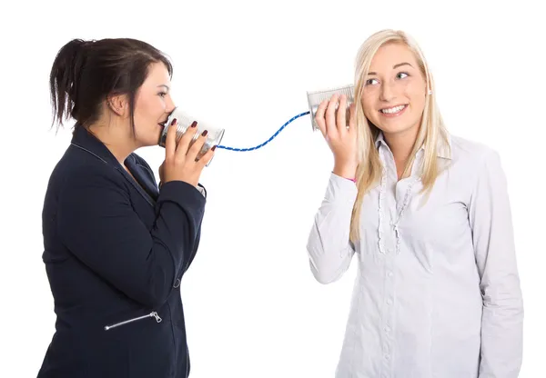 Woman talk: two young woman talking with tin can. Concept for co — Stock Photo, Image