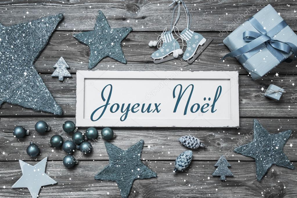 Merry Christmas card in blue and white with french text on woode