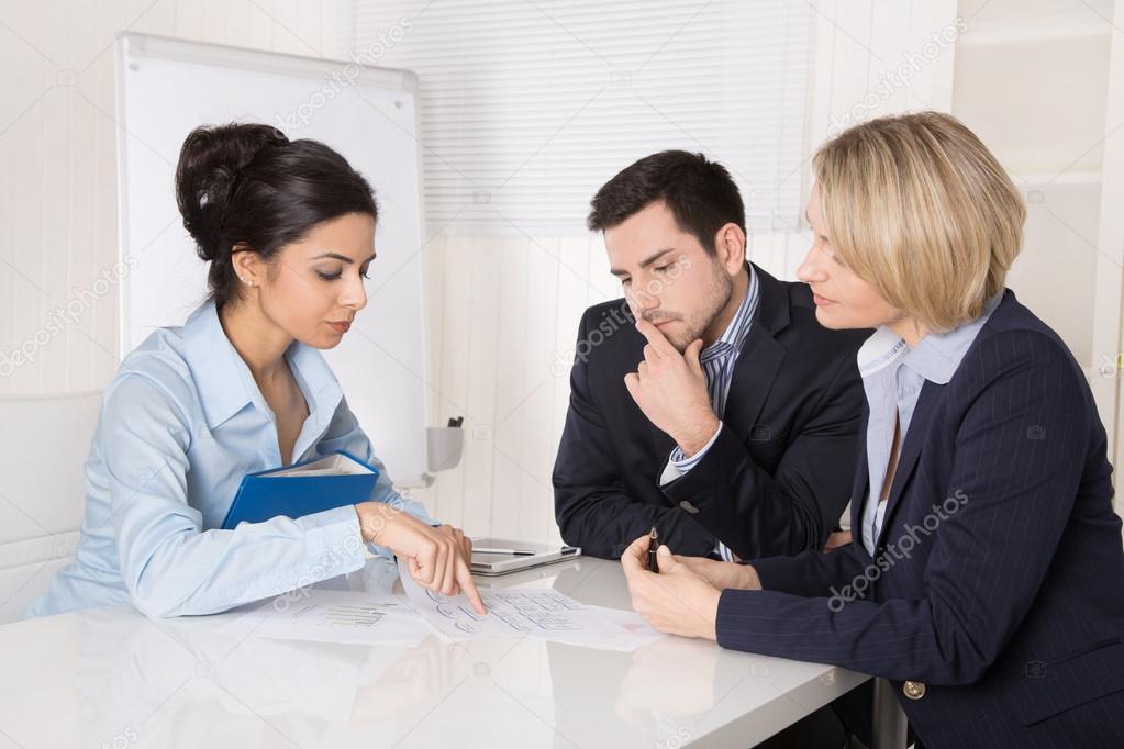 Group of a professional business team sitting at the table talki