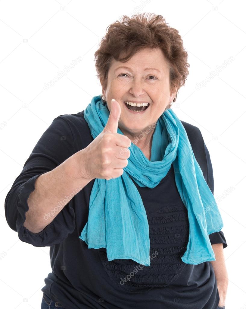 Happy isolated older lady wearing blue clothes with thumb up ges