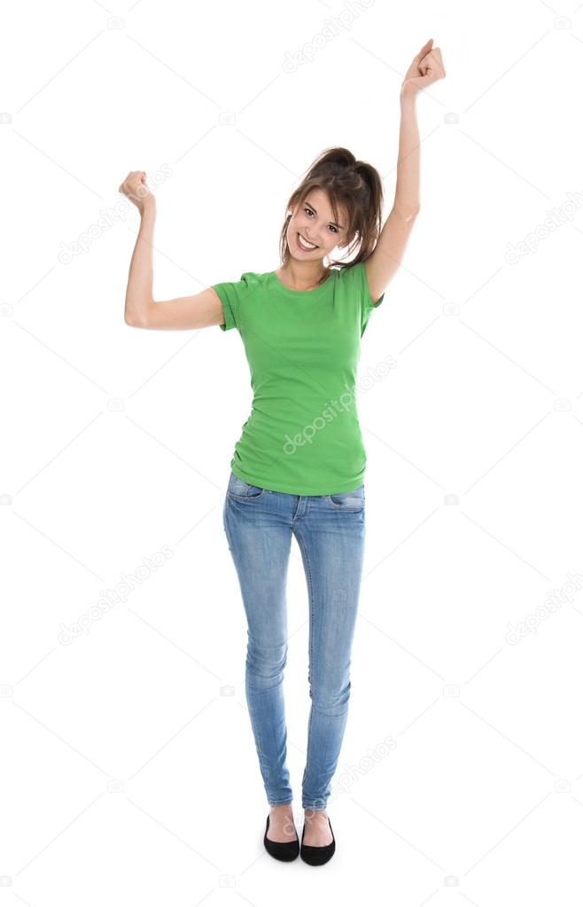 Isolated young woman in green shirt and blue jeans cheering and