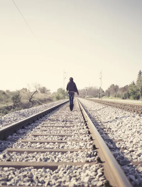 Woman walking on railway tracks — Stock Photo, Image