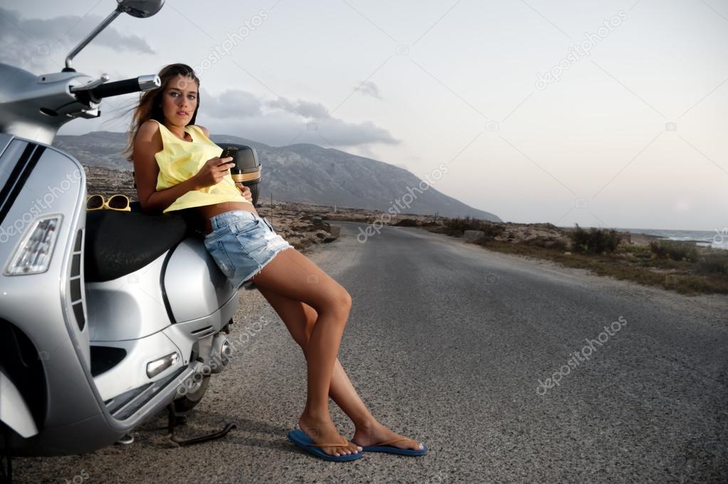 Young female enjoys a motorcycle trip