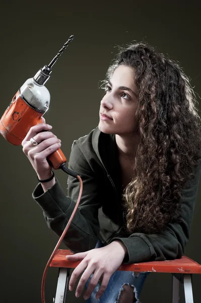 Young female working with drill — Stock Photo, Image