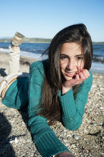 Wesoła, młoda kobieta, leżąc na plaży — Zdjęcie stockowe