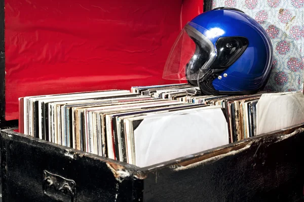 Helmet on a trunk with vinyl records — Stock Photo, Image