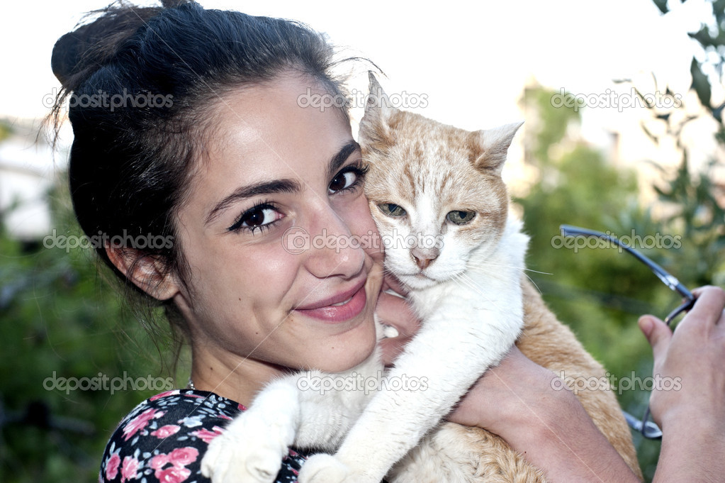 Young female holding her loving cat