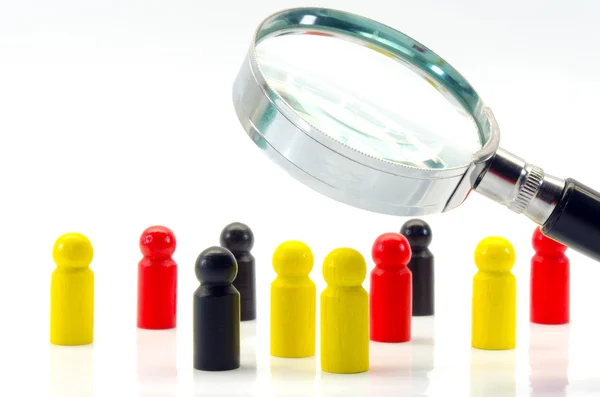 Game figures and magnifying class — Stock Photo, Image