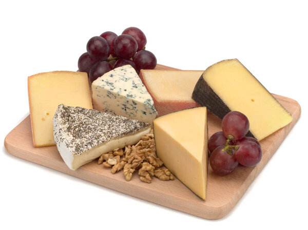 A wooden board with cheese, nuts, grapes