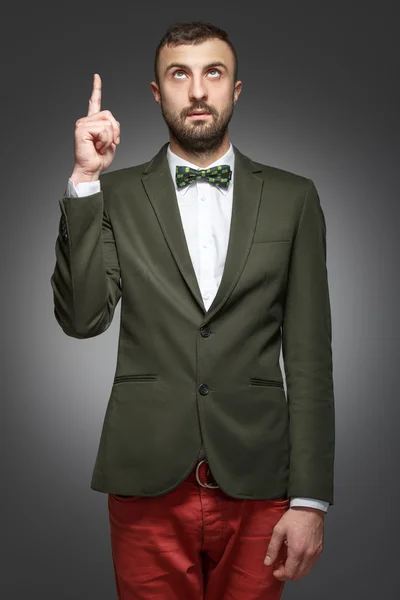 Young man in a green suit, shows up — Stock Photo, Image