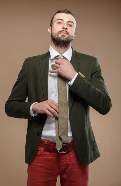 Young man in a green suit with a tie — Stock Photo, Image