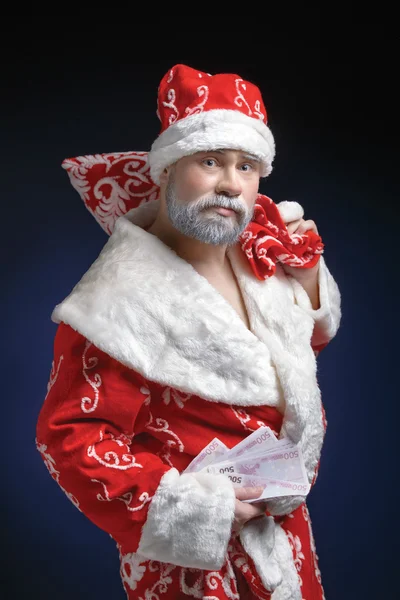 Portrait of Santa, who holds the money on a blue background — Stock Photo, Image