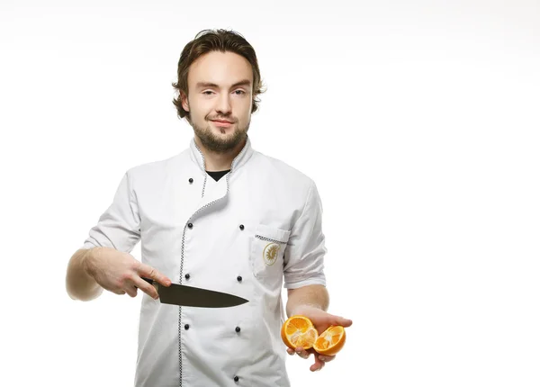 Chef cuts the orange — Stock Photo, Image