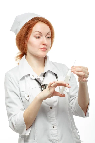 Oman doctor prepares a syringe for injection. On a white backgro — Stock Photo, Image