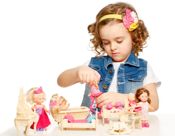 Little girl playing with dolls. — Stock Photo, Image