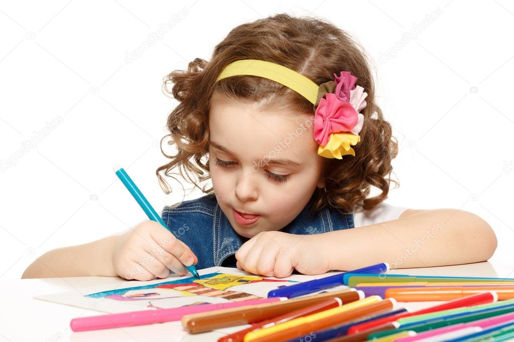 Little girl with felt-tip pen drawing in kindergarten