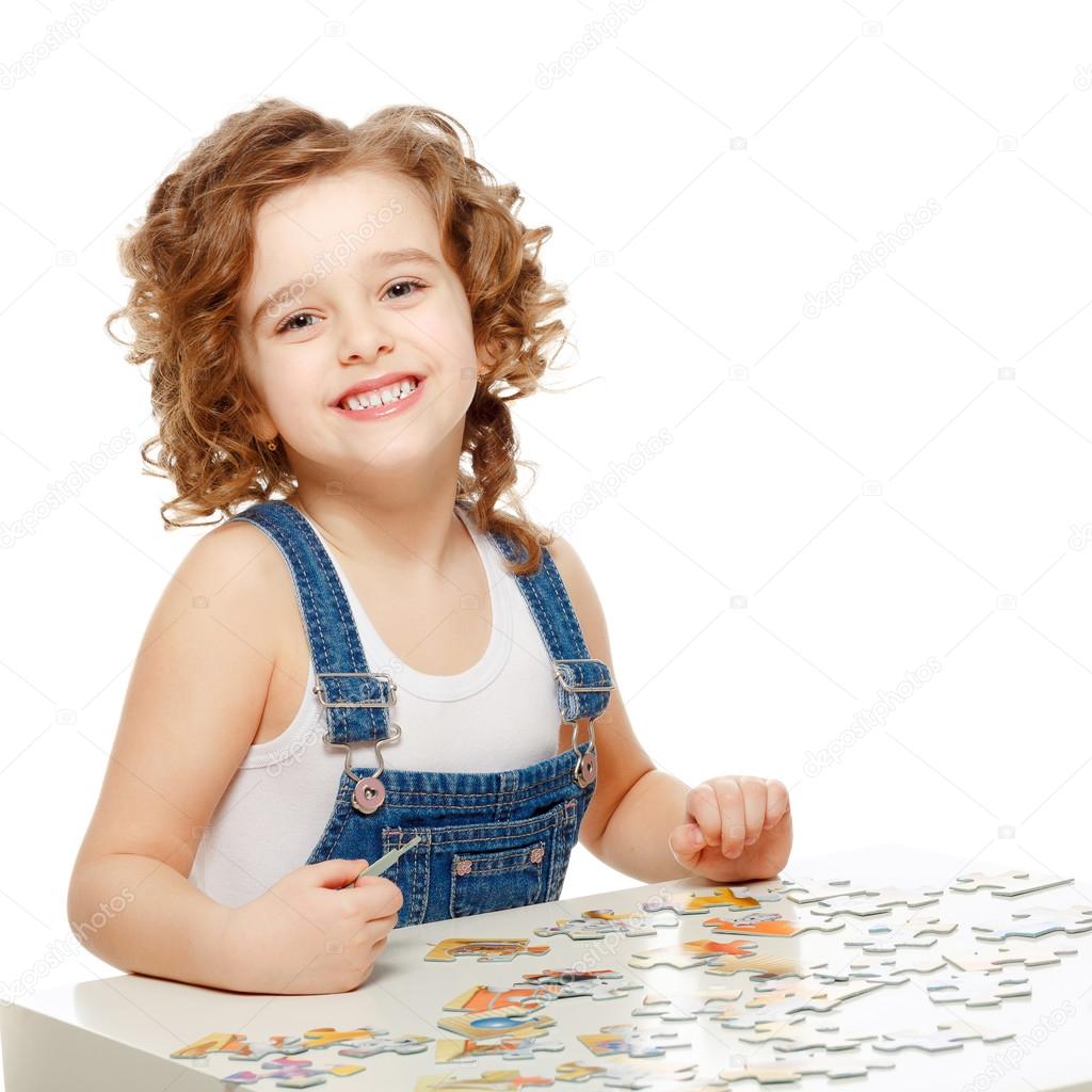 Little baby playing in the puzzle.