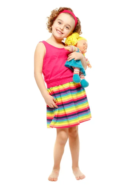 Little girl holding a doll. White background — Stock Photo, Image