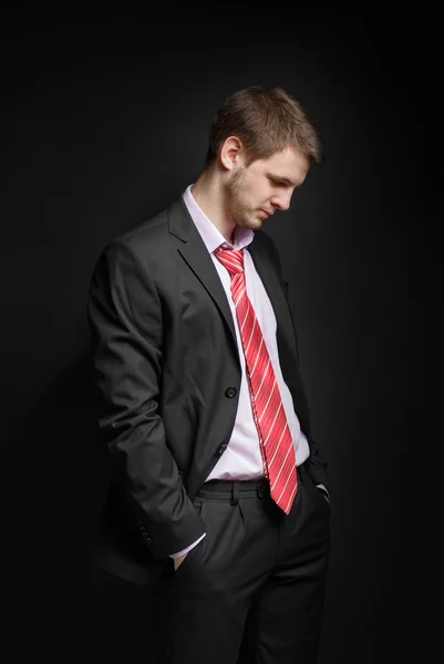 Businessman sitting in a free position, his head bowed. — Stock Photo, Image
