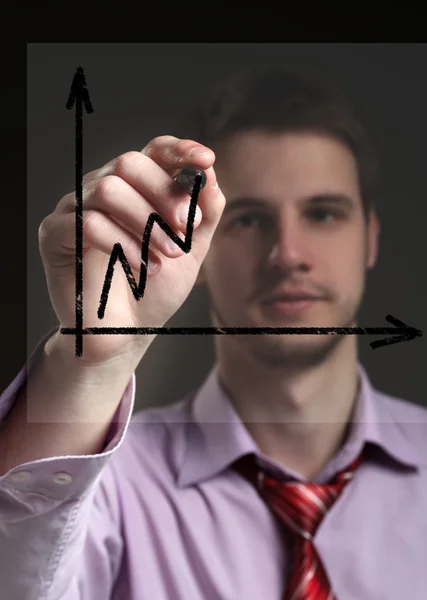 Businessman draws on a transparent screen graphics. Concept - pr — Stock Photo, Image