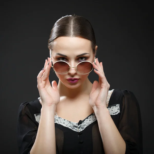 Beautiful girl takes off her glasses — Stock Photo, Image