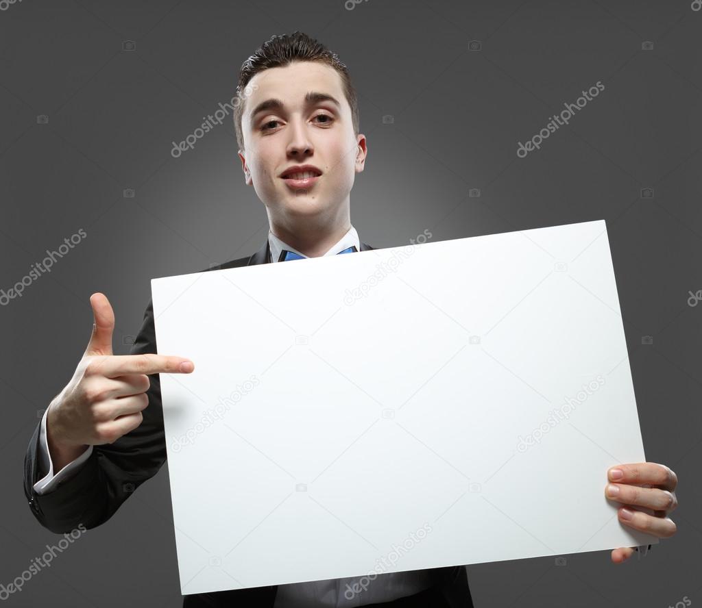 Young man holding a whiteboard. Concept - a demonstration of ach