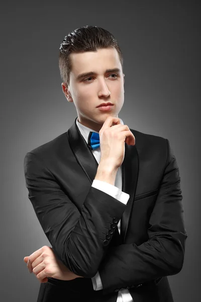 Young man is standing lost in thought — Stock Photo, Image