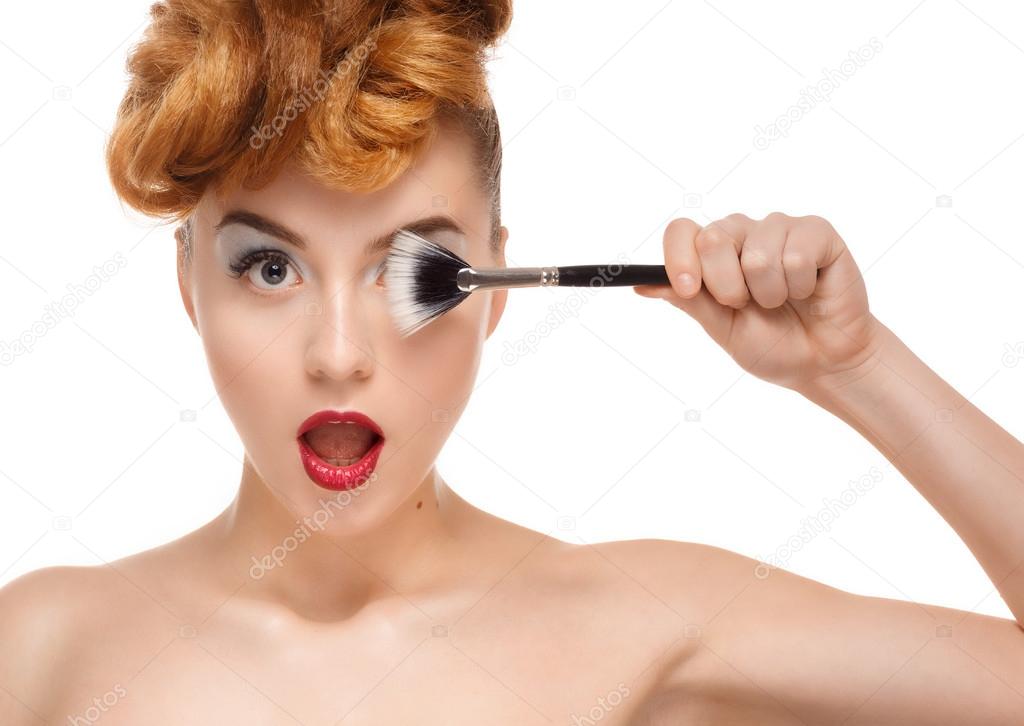 Beauty portrait of pretty woman with brush for makeup