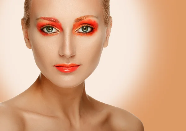 Το όμορφο μοντέλο γυναίκα πρόσωπο με πορτοκαλί μακιγιάζ. — Φωτογραφία Αρχείου