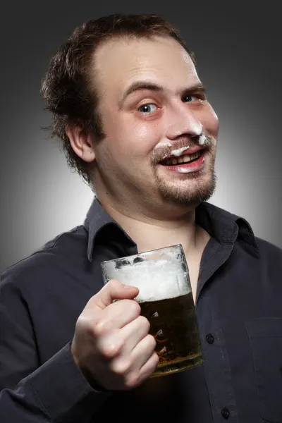 Happy man drinking beer from the mug — Stock Photo, Image