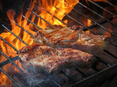 A top sirloin steak flame broiled on a barbecue, shallow depth o clipart