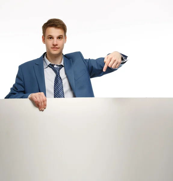 Young businessman holding a whiteboard. — Stock Photo, Image