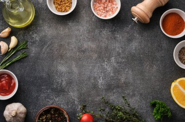 Food Background. Herbs and spices on grey stone table
