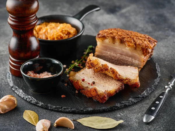 Roasted pork belly. Crispy Roast Pork Belly with stewed cabbage and spices. CLose-up.