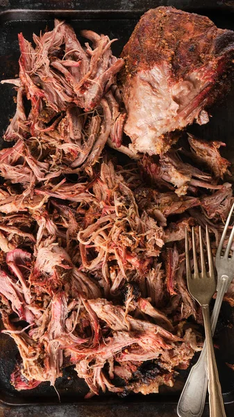 Traditional barbecue pulled pork. Slow cooked pulled pork shoulder. Juicy pork meat cooked in a smoker by low and slow.