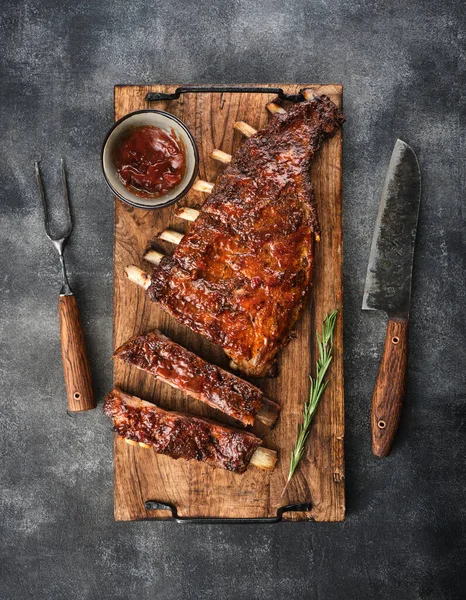 Delicious smoked pork ribs glazed in BBQ sauce. Top view.